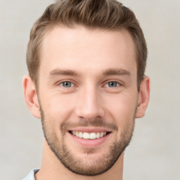 Joyful white young-adult male with short  brown hair and grey eyes