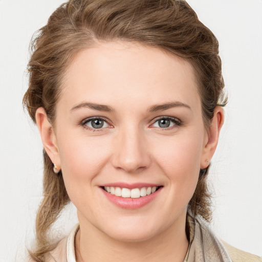 Joyful white young-adult female with medium  brown hair and grey eyes