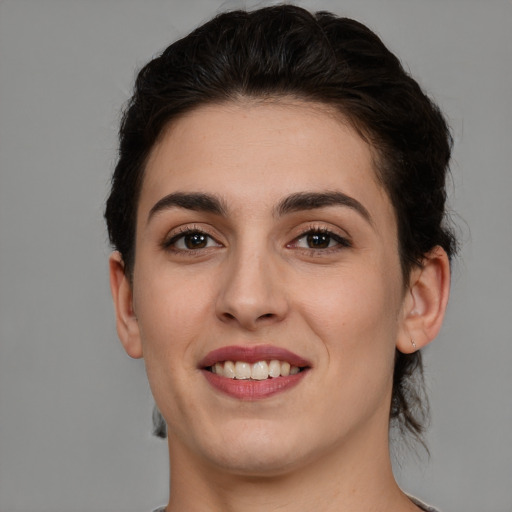 Joyful white young-adult female with long  brown hair and brown eyes