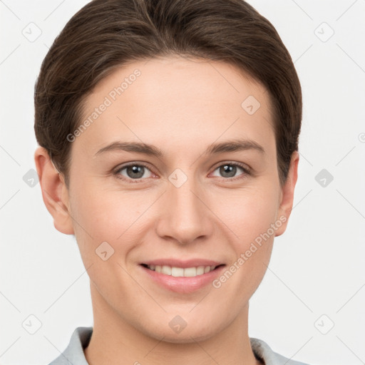 Joyful white young-adult female with short  brown hair and grey eyes