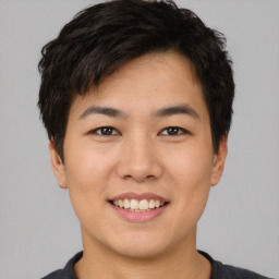 Joyful asian young-adult male with short  brown hair and brown eyes