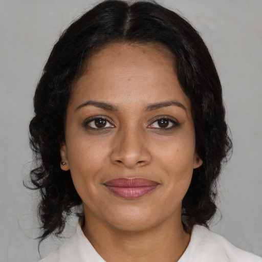 Joyful black young-adult female with medium  black hair and brown eyes