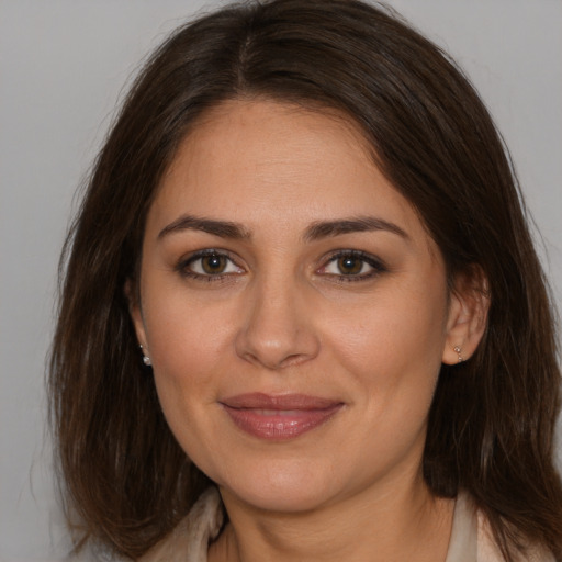 Joyful white young-adult female with medium  brown hair and brown eyes