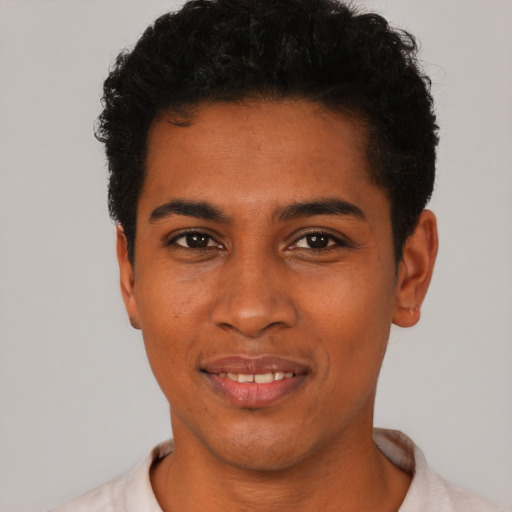 Joyful latino young-adult male with short  black hair and brown eyes