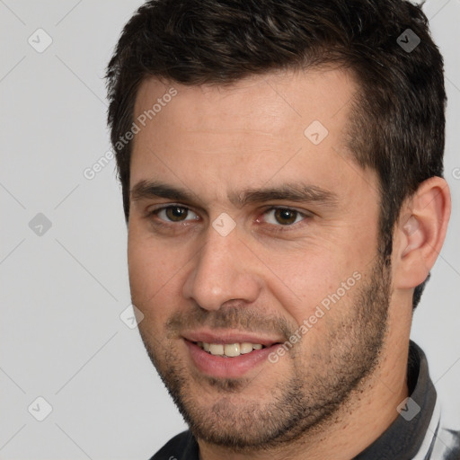 Joyful white young-adult male with short  brown hair and brown eyes