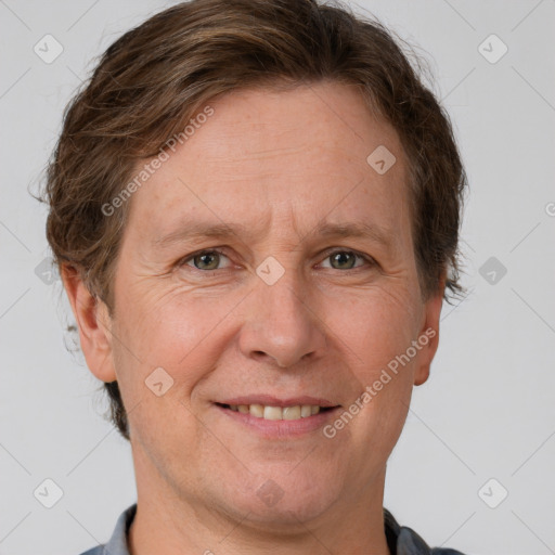 Joyful white adult male with short  brown hair and grey eyes