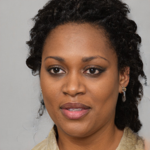 Joyful black adult female with medium  black hair and brown eyes
