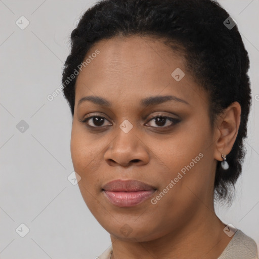 Joyful black young-adult female with short  black hair and brown eyes