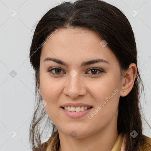 Joyful white young-adult female with long  brown hair and brown eyes