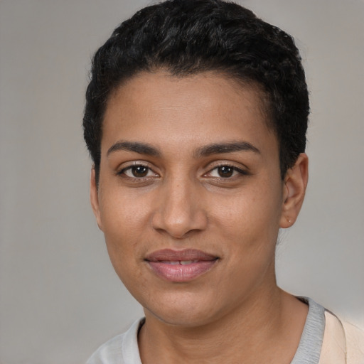 Joyful latino young-adult female with short  black hair and brown eyes