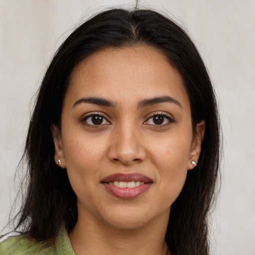 Joyful latino young-adult female with long  brown hair and brown eyes