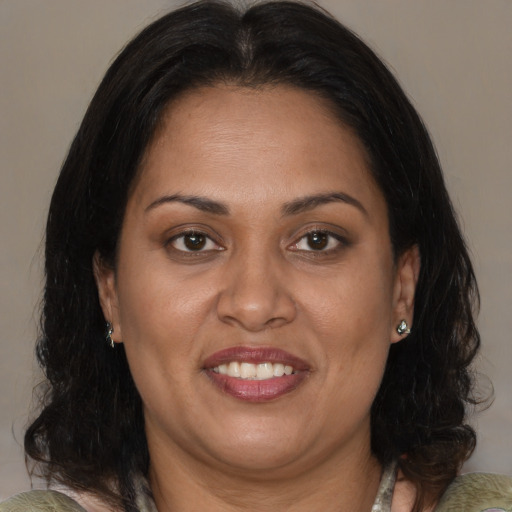 Joyful asian adult female with medium  brown hair and brown eyes