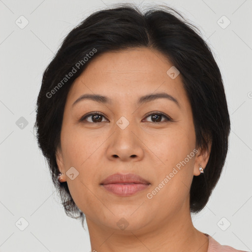 Joyful asian adult female with medium  brown hair and brown eyes