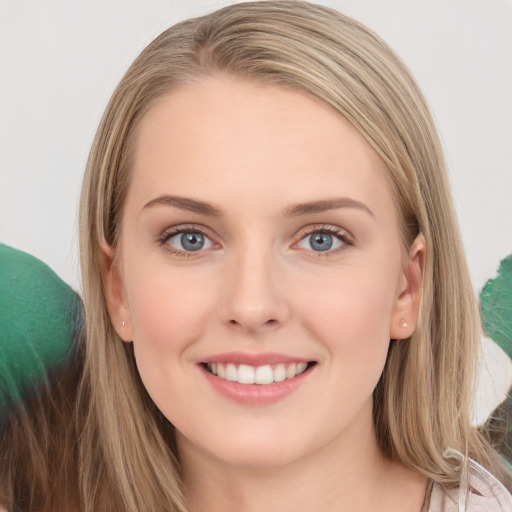 Joyful white young-adult female with long  brown hair and blue eyes