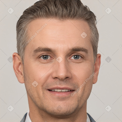 Joyful white adult male with short  brown hair and grey eyes