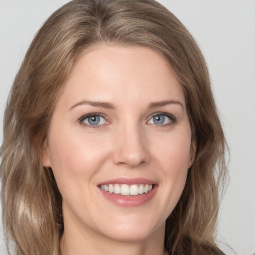 Joyful white young-adult female with medium  brown hair and green eyes