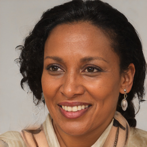 Joyful black adult female with medium  brown hair and brown eyes
