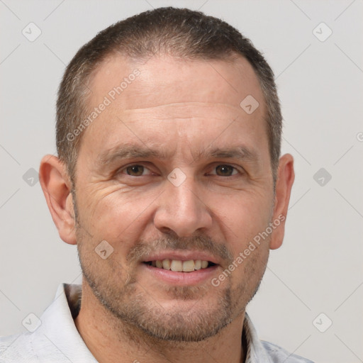 Joyful white adult male with short  brown hair and brown eyes