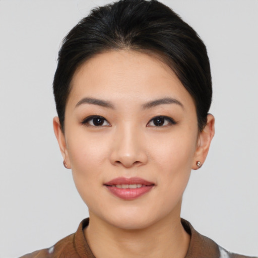 Joyful asian young-adult female with short  brown hair and brown eyes