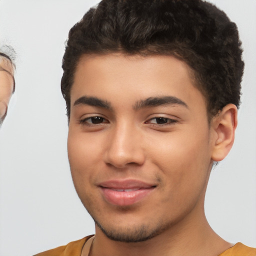 Joyful latino young-adult male with short  brown hair and brown eyes