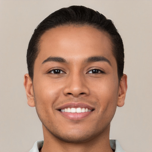 Joyful latino young-adult male with short  brown hair and brown eyes