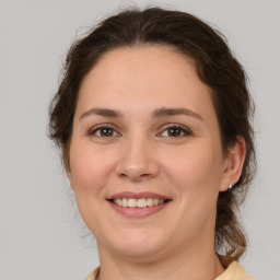 Joyful white young-adult female with medium  brown hair and brown eyes