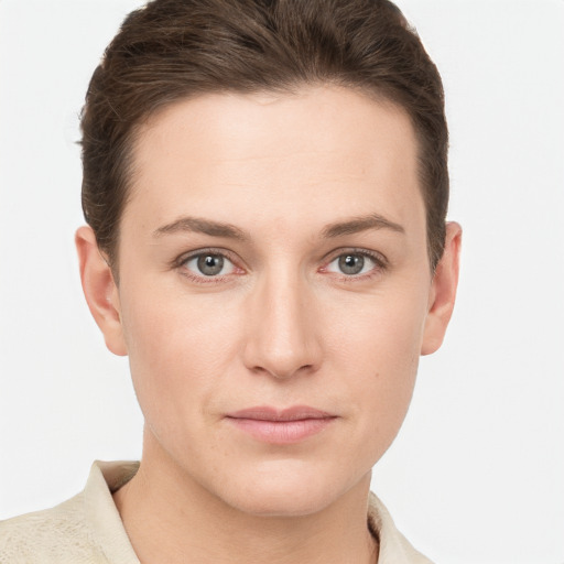 Joyful white young-adult female with short  brown hair and grey eyes