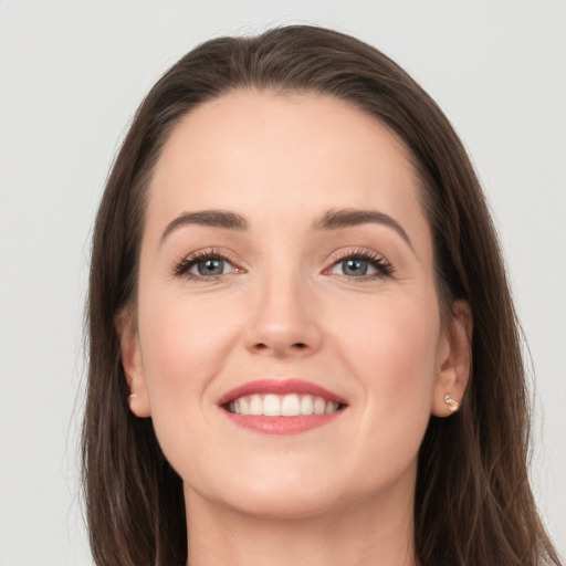 Joyful white young-adult female with long  brown hair and grey eyes