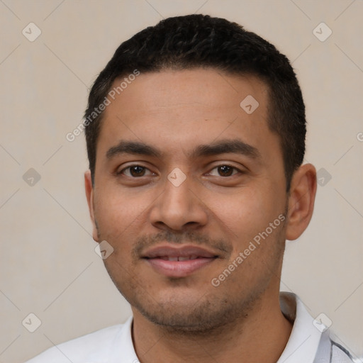 Joyful latino young-adult male with short  black hair and brown eyes