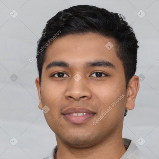 Joyful latino young-adult male with short  black hair and brown eyes