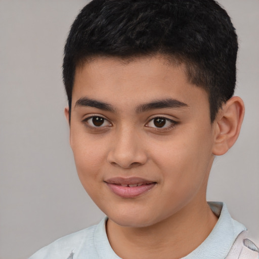 Joyful latino child male with short  brown hair and brown eyes