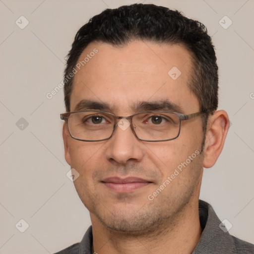 Joyful white adult male with short  black hair and brown eyes