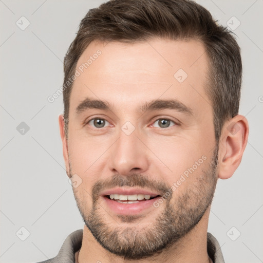 Joyful white young-adult male with short  brown hair and brown eyes