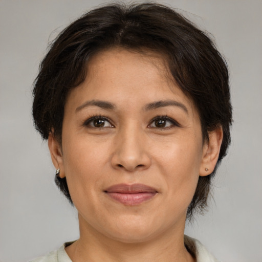 Joyful white adult female with medium  brown hair and brown eyes