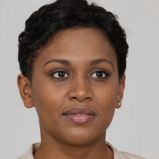 Joyful black young-adult female with short  brown hair and brown eyes