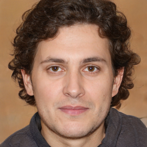 Joyful white young-adult male with medium  brown hair and brown eyes