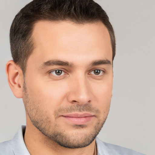 Joyful white young-adult male with short  brown hair and brown eyes