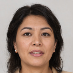 Joyful asian adult female with medium  brown hair and brown eyes