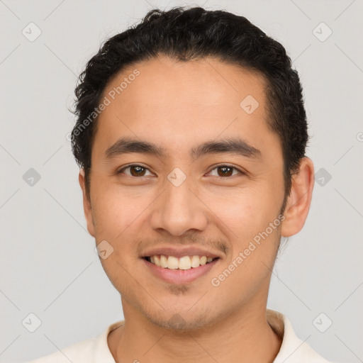 Joyful latino young-adult male with short  brown hair and brown eyes