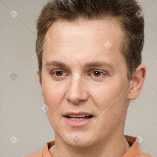 Joyful white adult male with short  brown hair and brown eyes