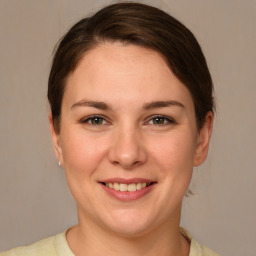 Joyful white young-adult female with medium  brown hair and brown eyes