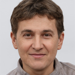 Joyful white adult male with short  brown hair and brown eyes