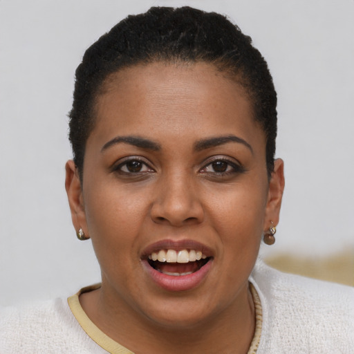 Joyful black young-adult female with short  brown hair and brown eyes