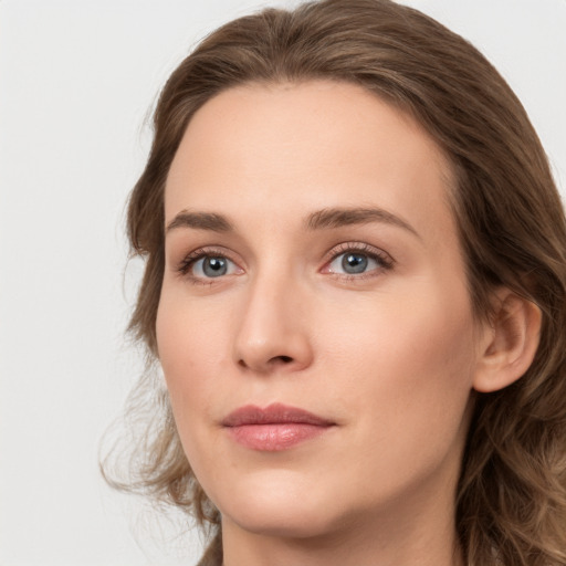 Joyful white young-adult female with long  brown hair and grey eyes