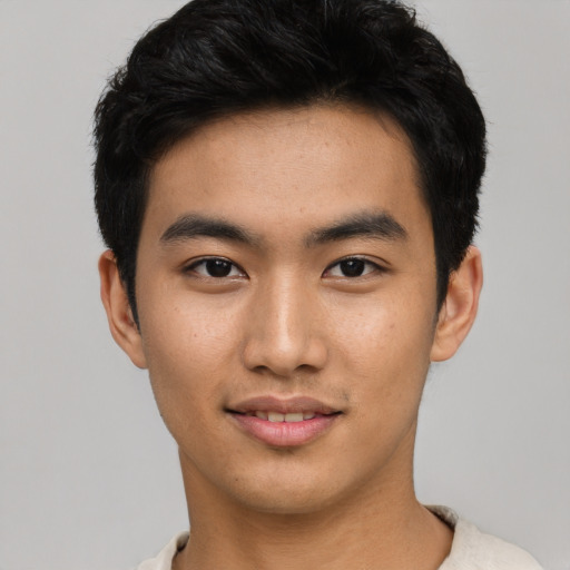 Joyful asian young-adult male with short  black hair and brown eyes