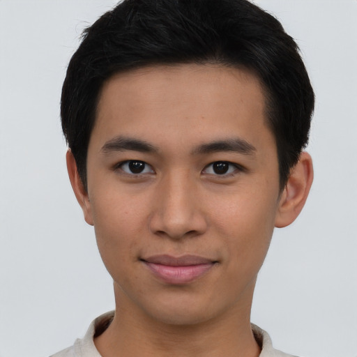Joyful asian young-adult male with short  brown hair and brown eyes