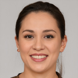 Joyful white young-adult female with medium  brown hair and brown eyes