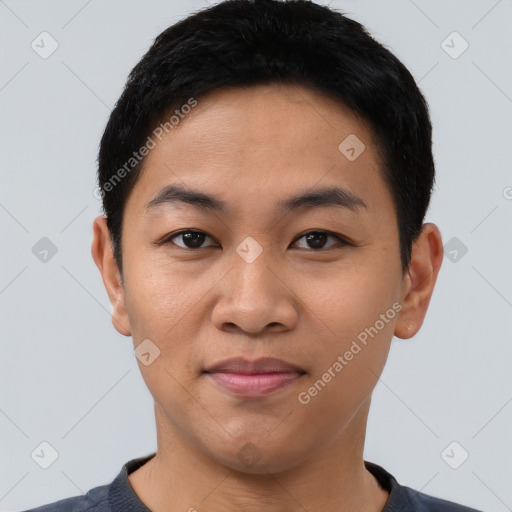 Joyful asian young-adult male with short  black hair and brown eyes