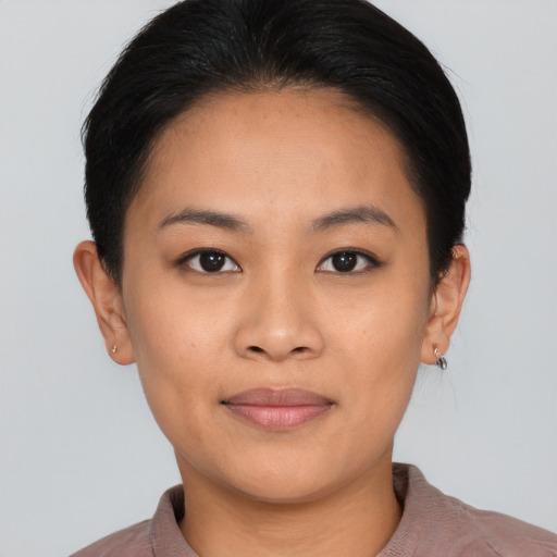 Joyful asian young-adult female with short  black hair and brown eyes