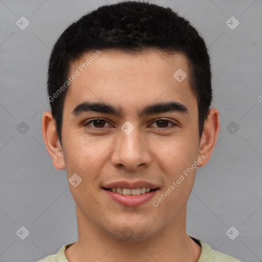 Joyful latino young-adult male with short  brown hair and brown eyes